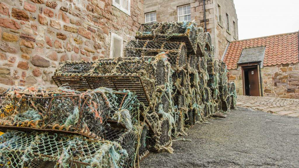 Lobster traps sitting at the Crail Harbour