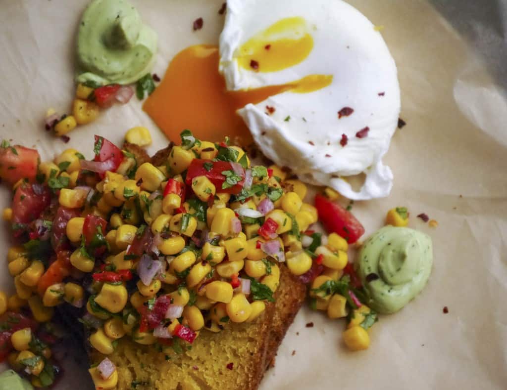 Cornbread topped with a corn salsa, a creme fresh diill cream and a runny poached egg
