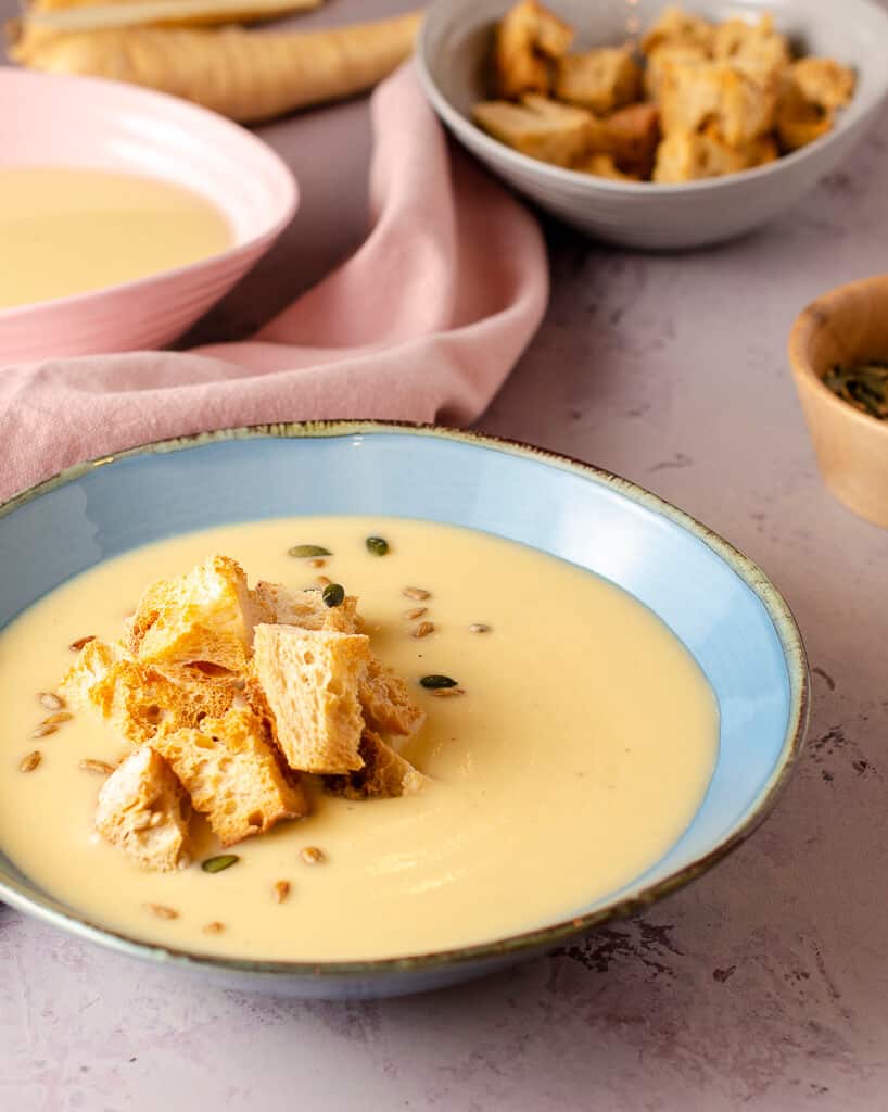 creamy parsnip & nutmeg soup with croutons in a blue bowl
