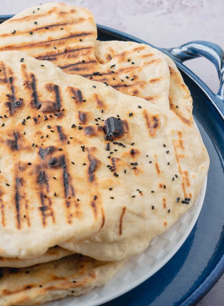 Closeup of flatbreads on a blue ceramic tray