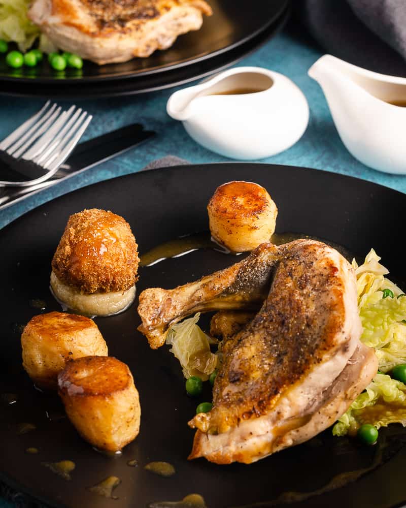 Guinea Fowl with pan fried greens, fondant potato and chicken leg bonbon with a chicken jus