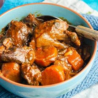 paprika beef casserole in a blue bowl closeup