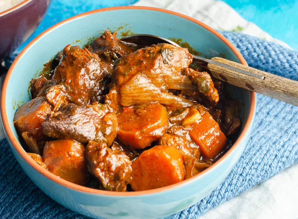 paprika beef casserole in a blue bowl closeup