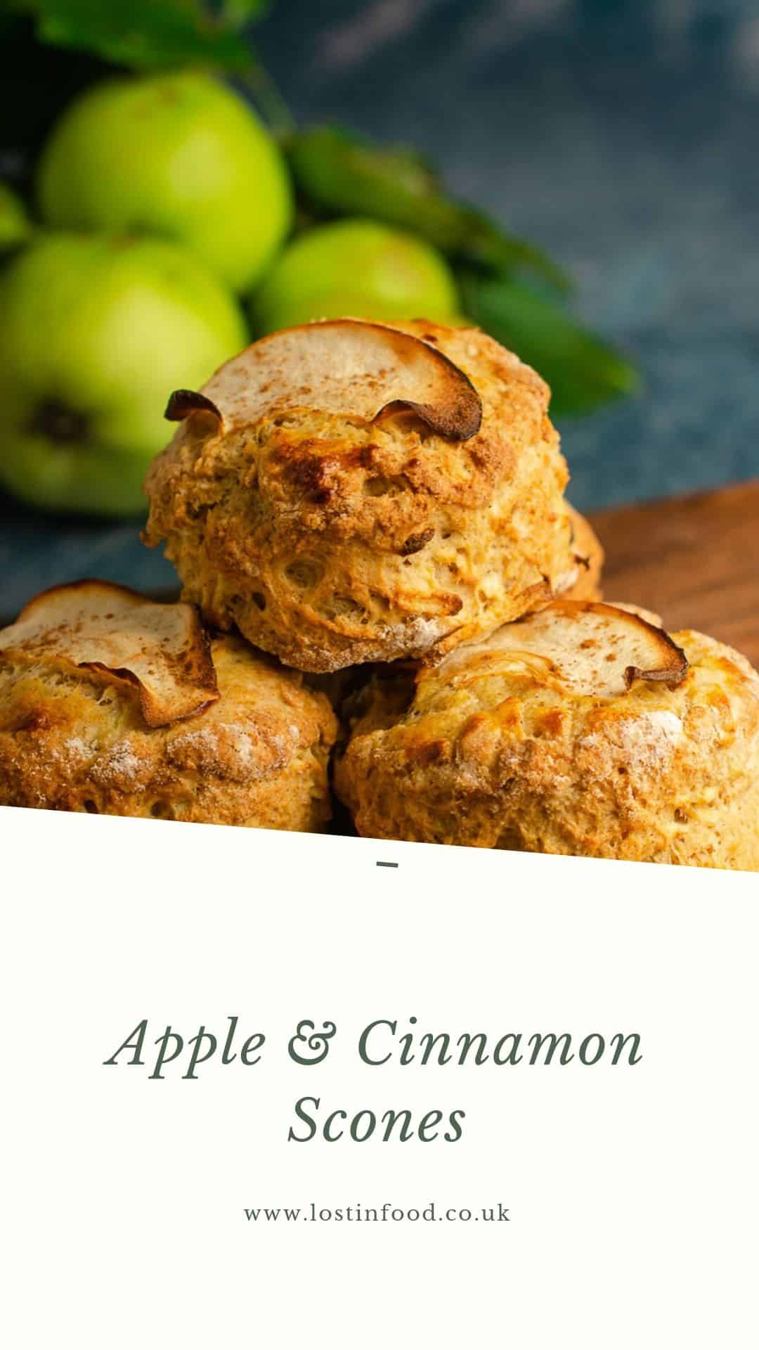 Fresh apple and cinnamon scones piled on a wooden board with freshly picked green apples still with their leaves on just slightly blurred in the background and a white banner at the bottom of the image with Apple & Cinnamon Scones and Lost in Food as the author.