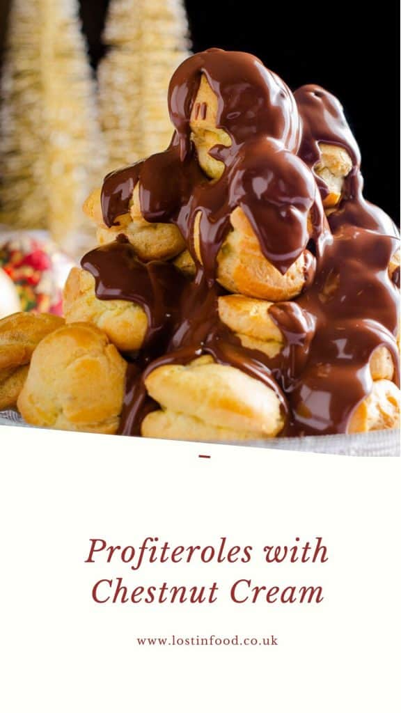 A tower of profiteroles filled with chestnut creme patisserie and warm melted chocolate over the top with some gold christmas trees in the back and text at the bottom which reads Profiteroles with Chestnut Cream and the Author name of Lost in Food.