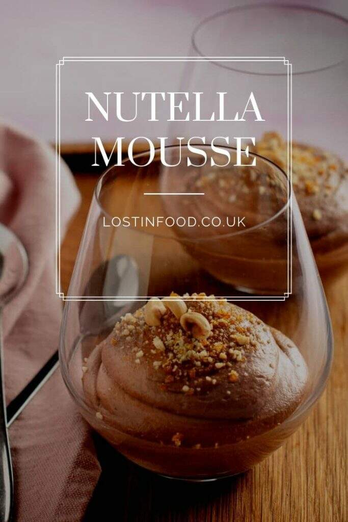 Pinterest image of 2 glasses of Nutella Mousse served on a wooden board with a pink napkin