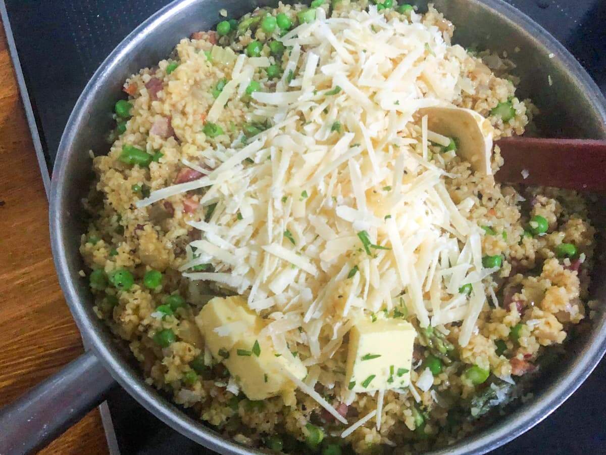 Adding cheese and butter to finish off a bulgar wheat risotto.