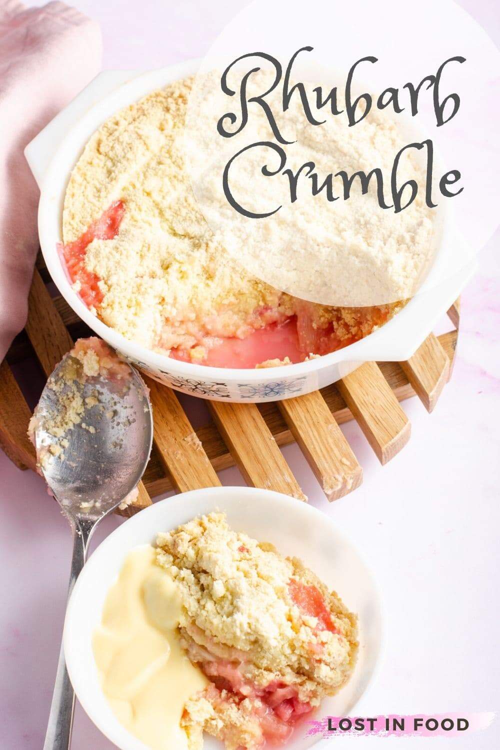 Rhubarb Crumble and custard in a white bowl and the serving dish behind.