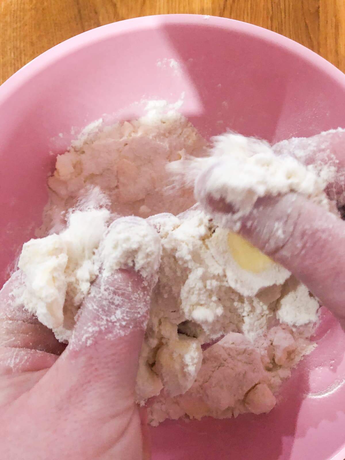 Step by step of making rhubarb crumble rubbing together flour, sugar and butter between your fingers.