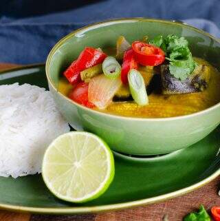 Vegetable and coconut curry served with rice and limes.