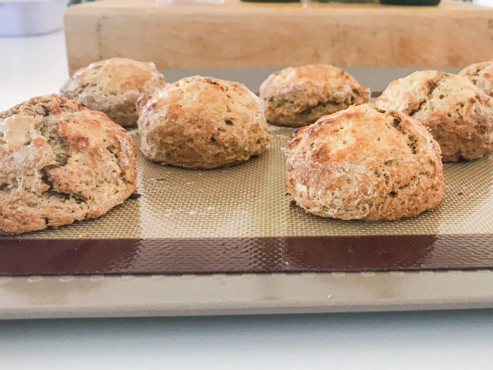 Apple and cinnamon scones fresh from the oven on a non stick baking mat to show the height of the scones.