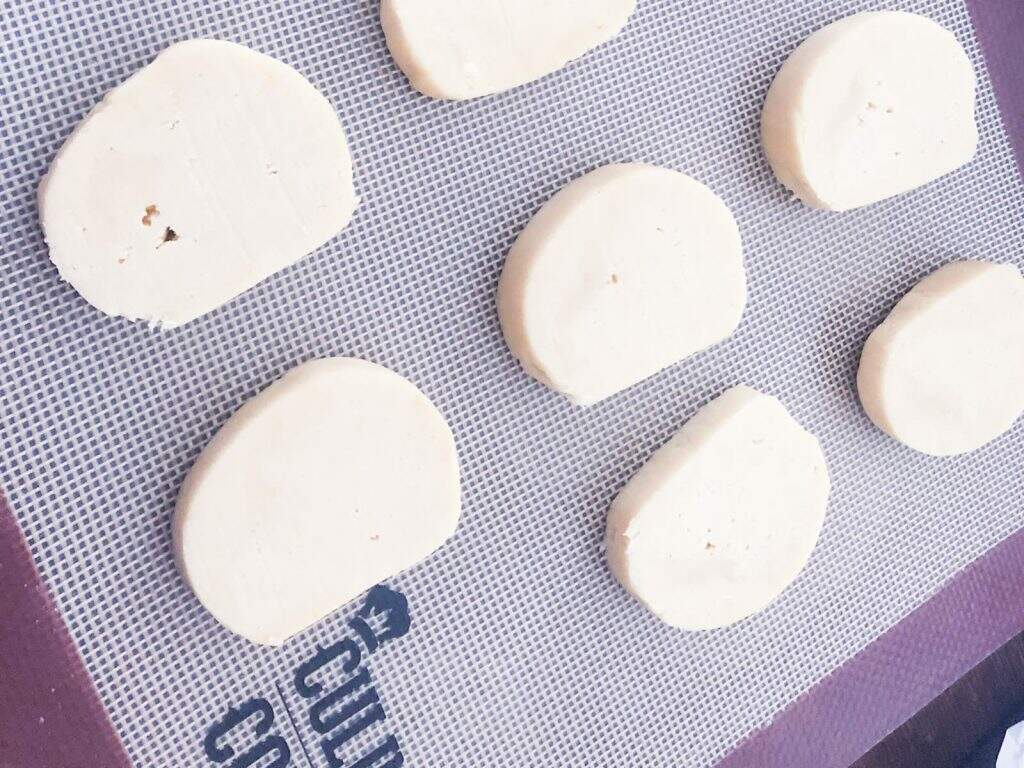 lemon butter biscuits cut and ready for the oven on a lined baking tray.