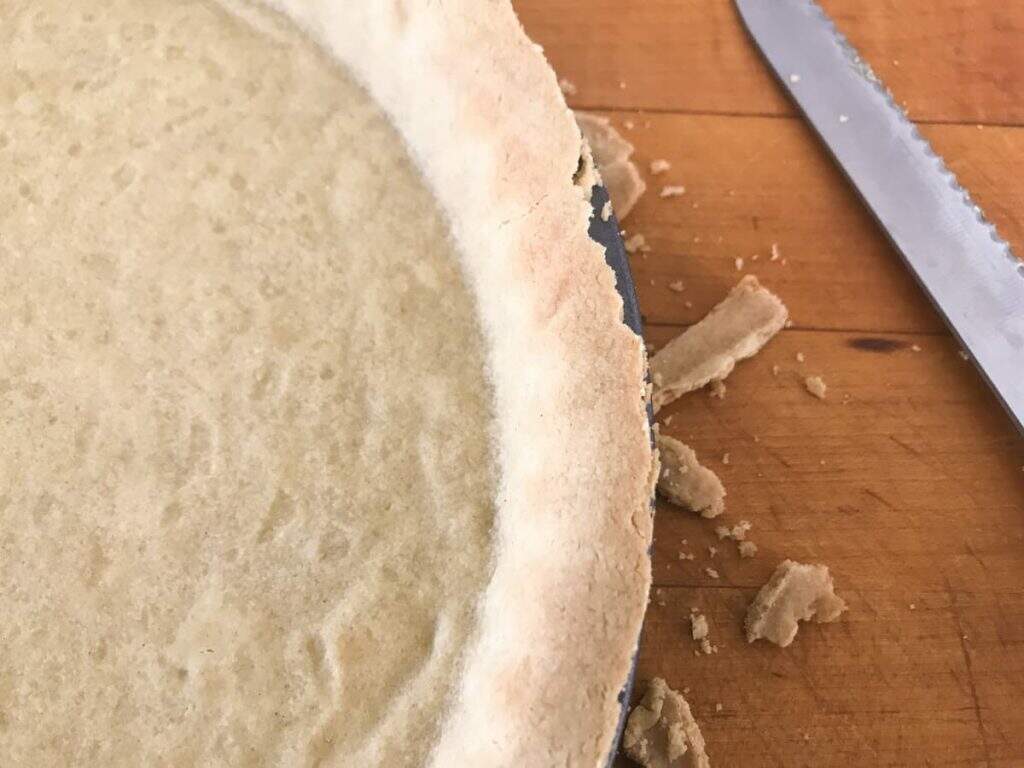 Shortcrust pastry tart showing how to trim the edges to give a neat finish.