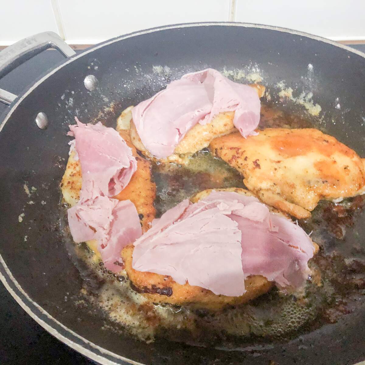 Pan fried chicken breast with ham on the top
