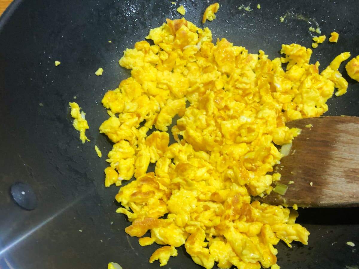 scrambling eggs in a frying pan