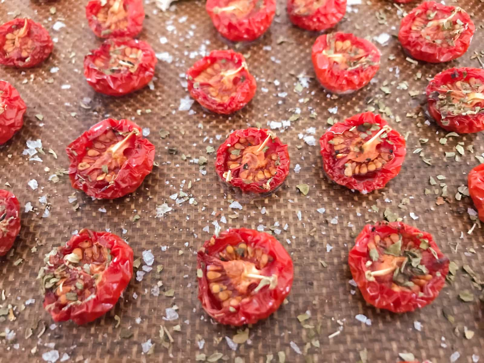 cherry tomatoes sliced in half after roasting in a very low oven for 3 hours.