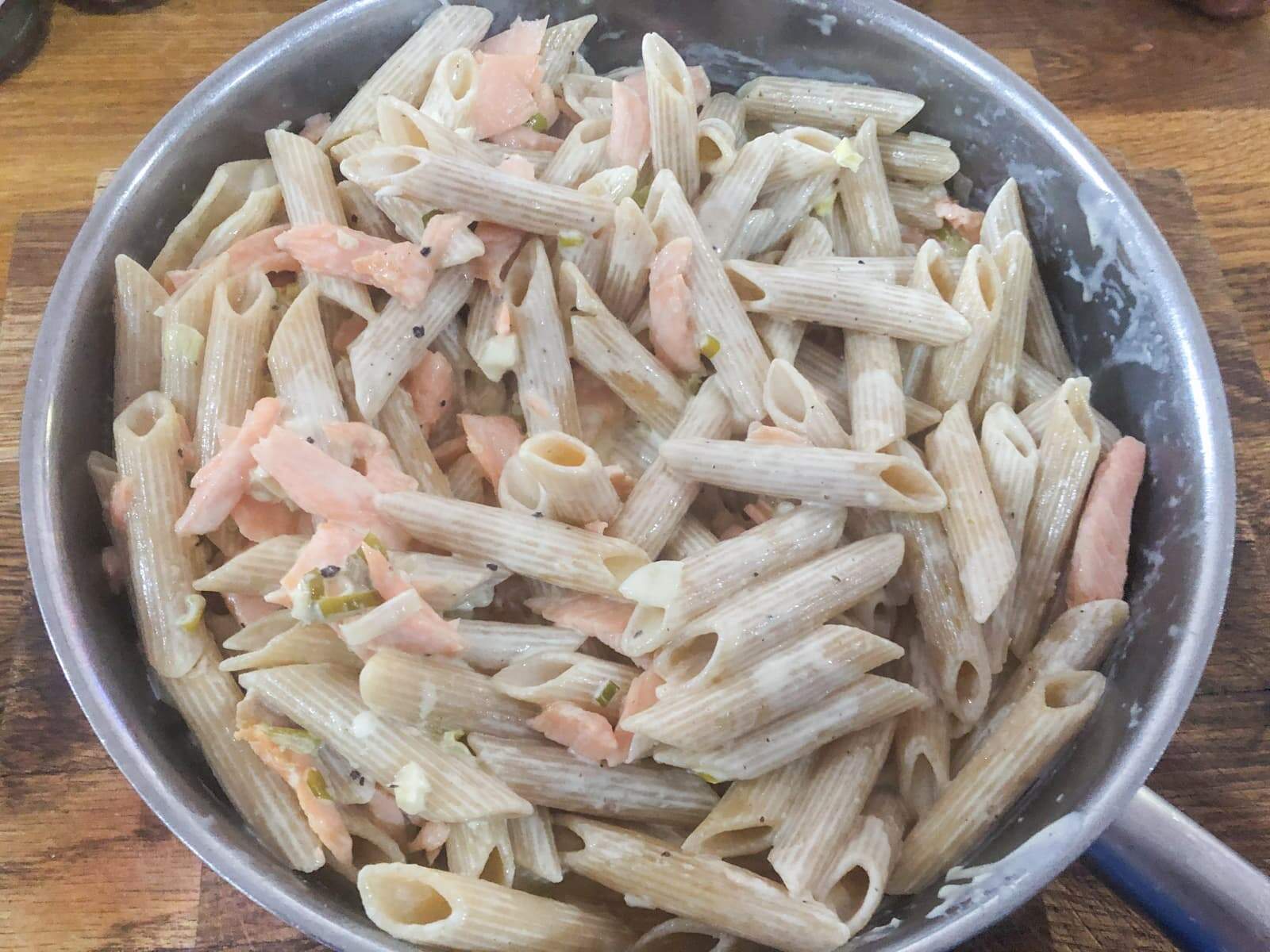 Creamy smoked salmon pasta in a large pan