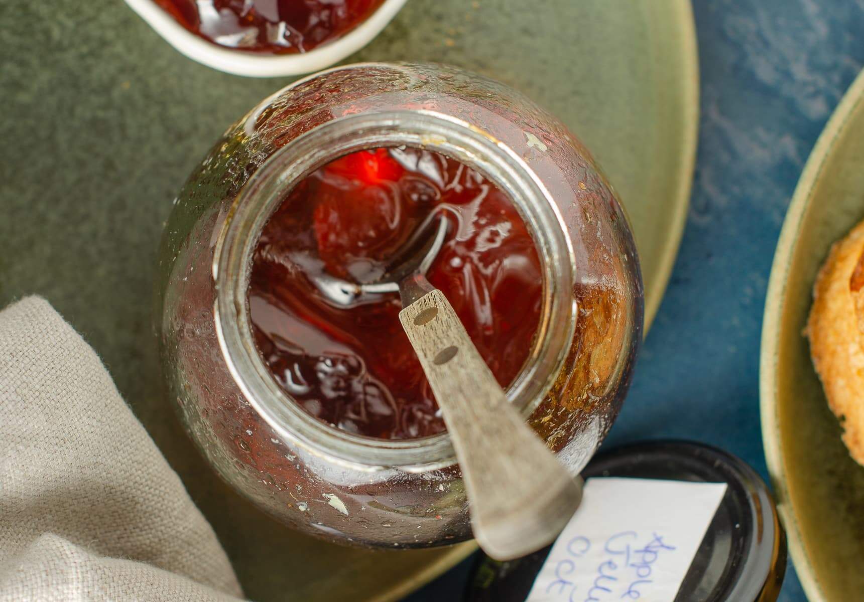 Looking down into a half full jar of apple jelly / jam