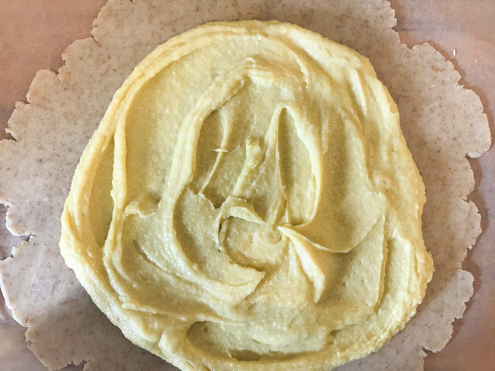 Frangipane spread onto pastry before fruit being added