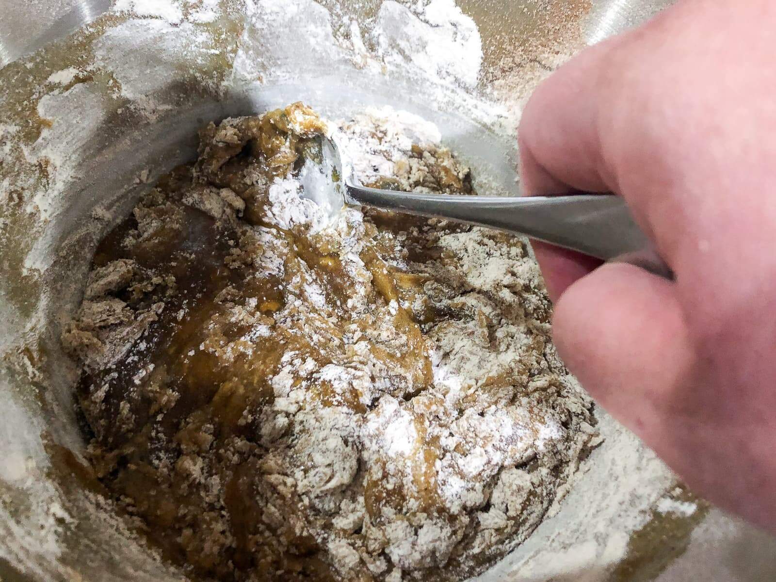 Mixing flour into wet ingredients for a spice cake