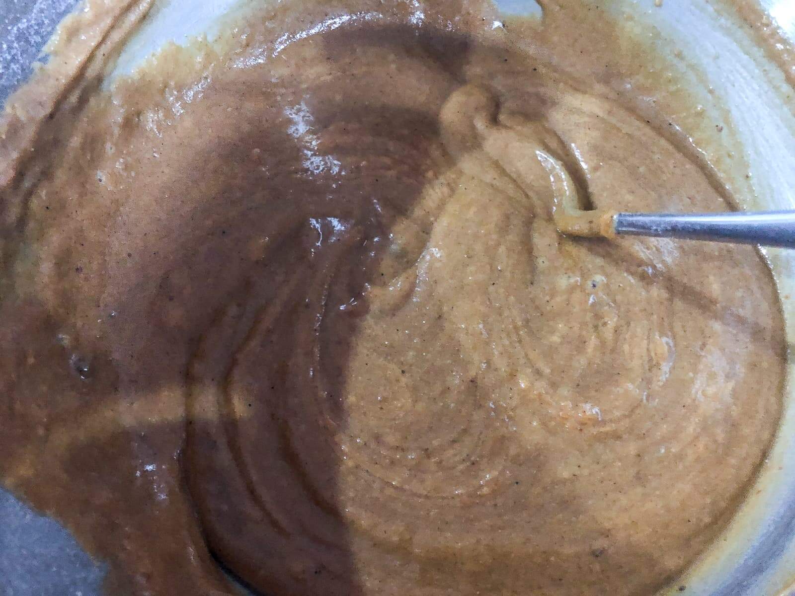 Spiced pumpkin cake batter in a mixing bowl