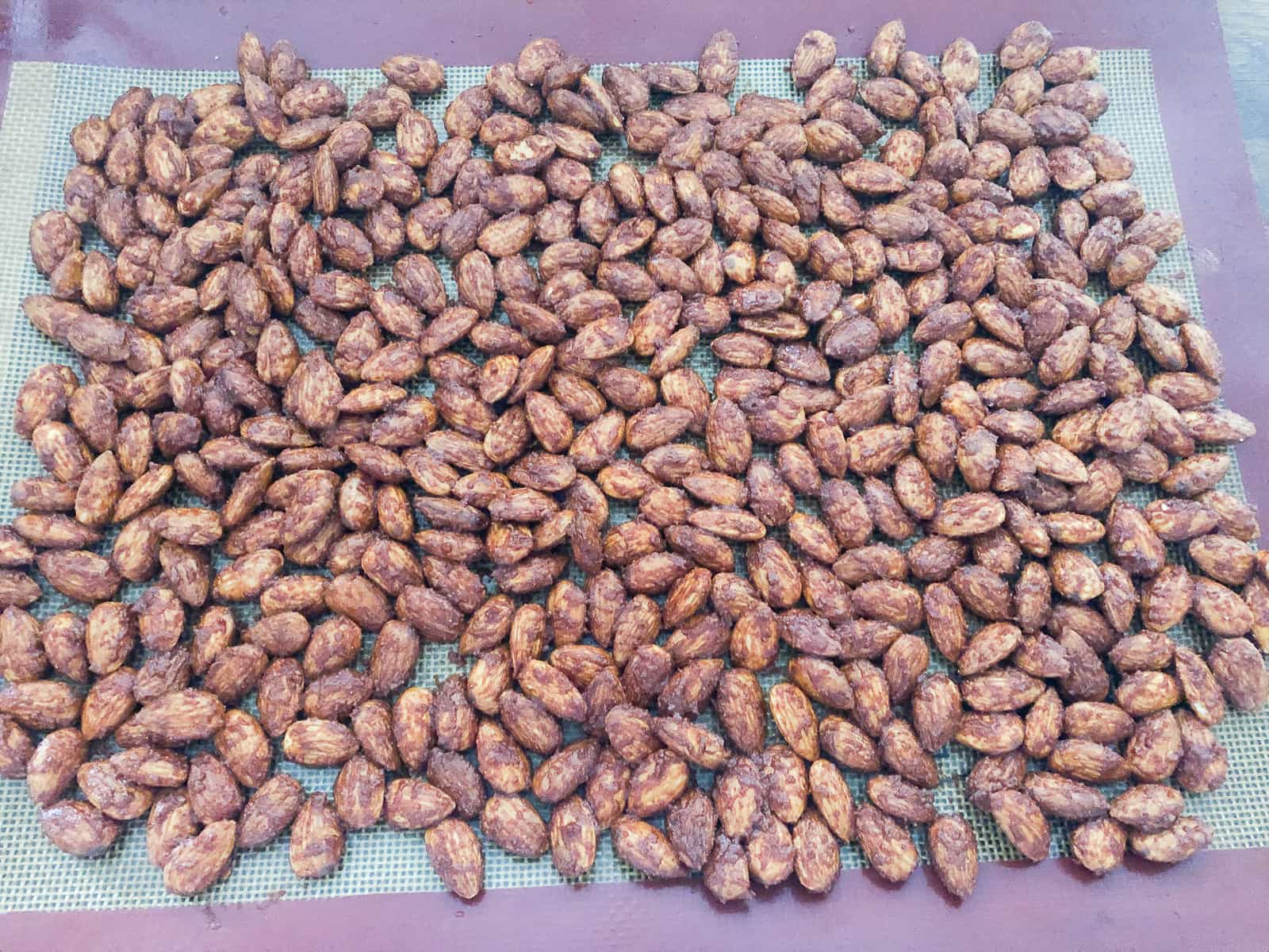 Almonds on a baking tray with a spice coating.