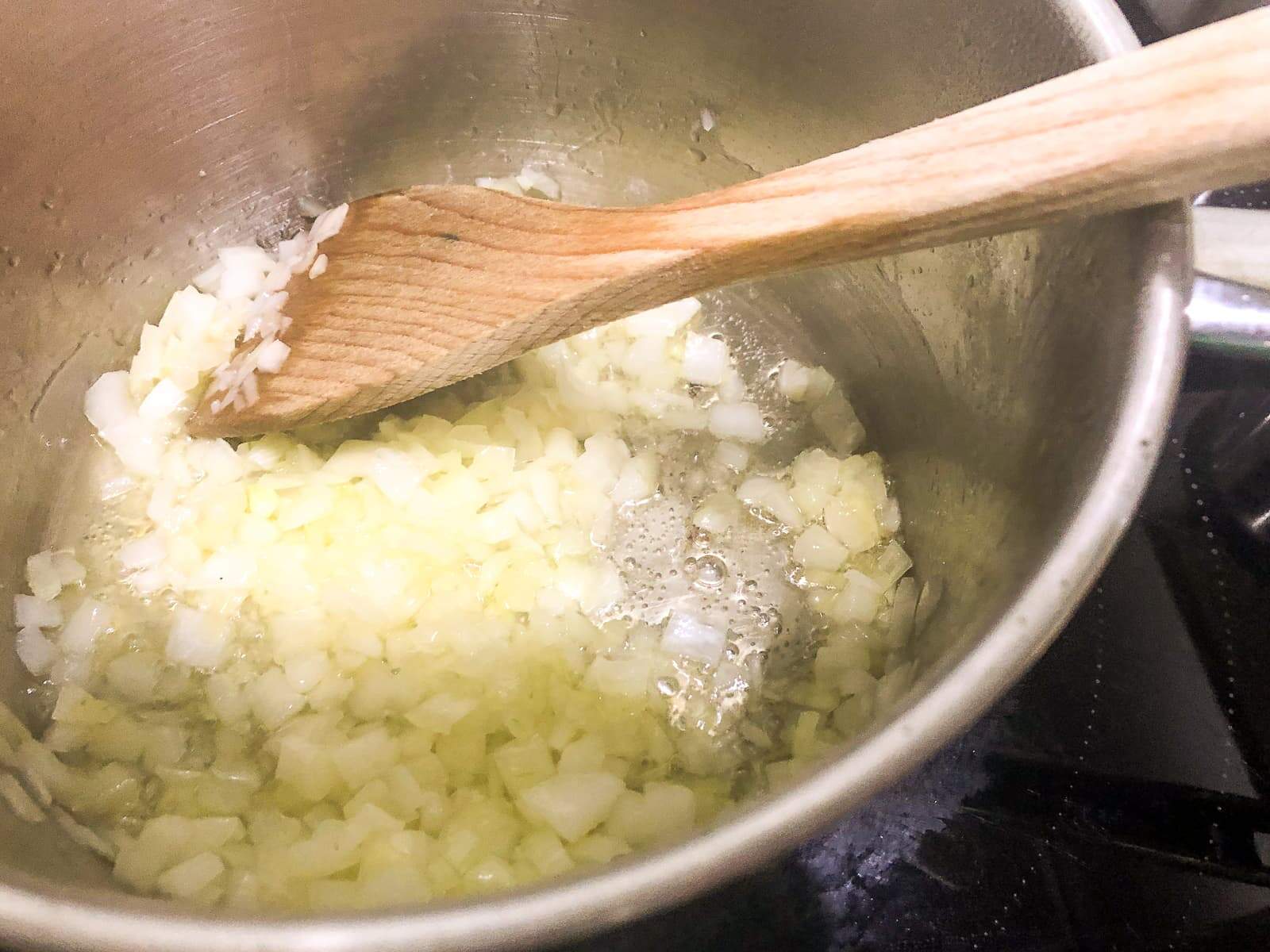 Diced onions and garlic sweating off in a bit of oil in a hot fry pan.
