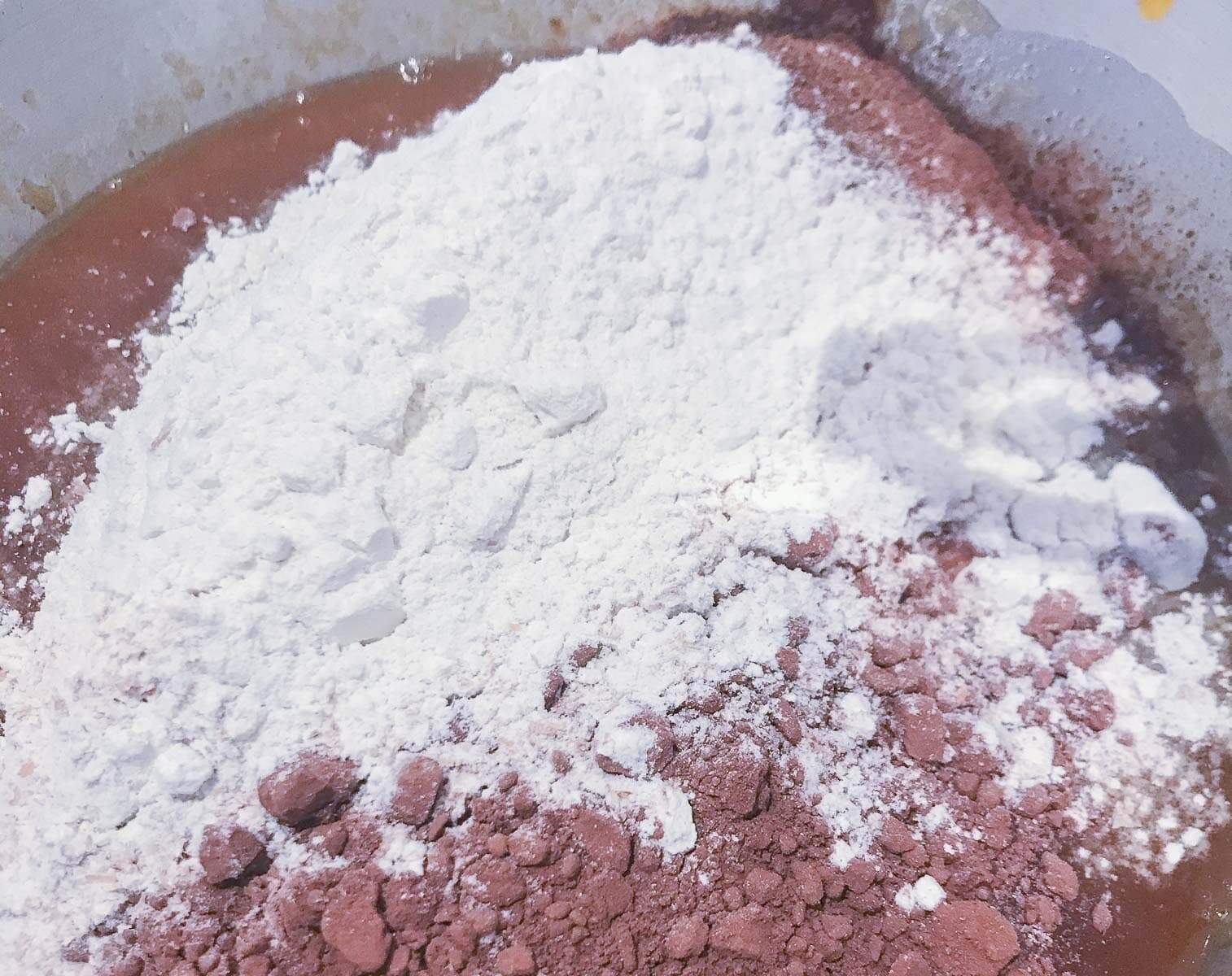 Flour and cocoa powder sieved into a bowl.