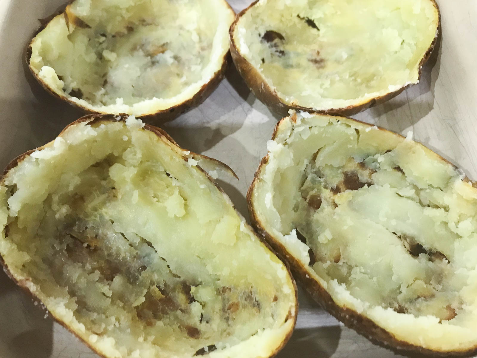 Baked potatoes with the insides scooped out to leave the baked skins.