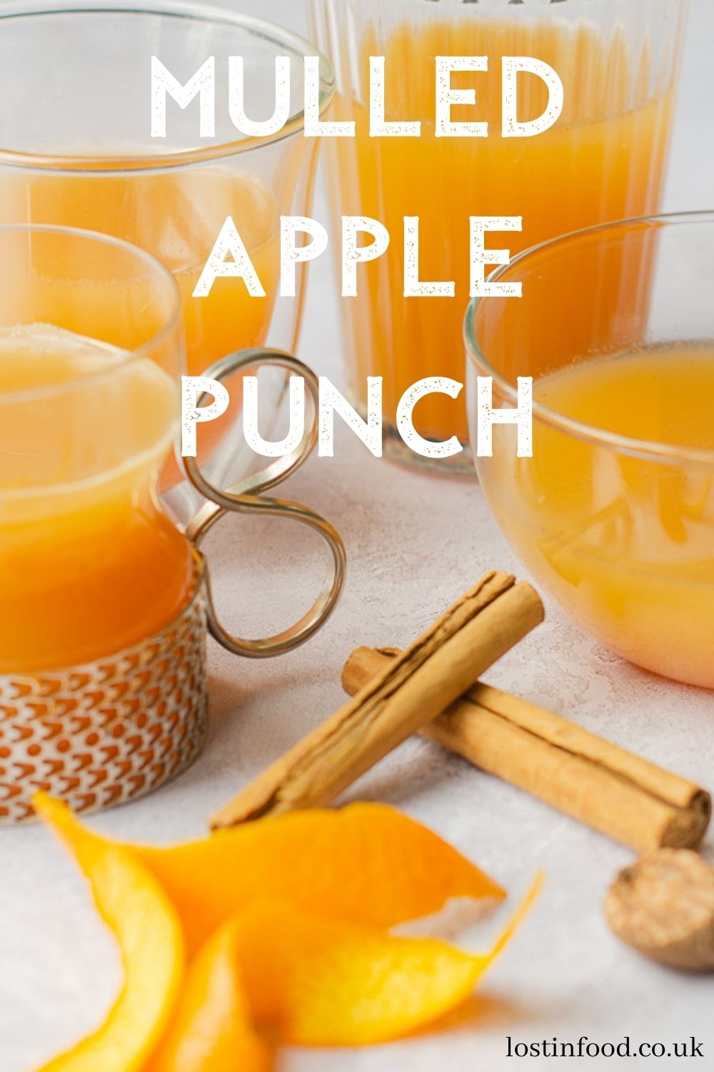 Pinterest graphic with different shapes and sizes of glasses filled with mulled apple juice.