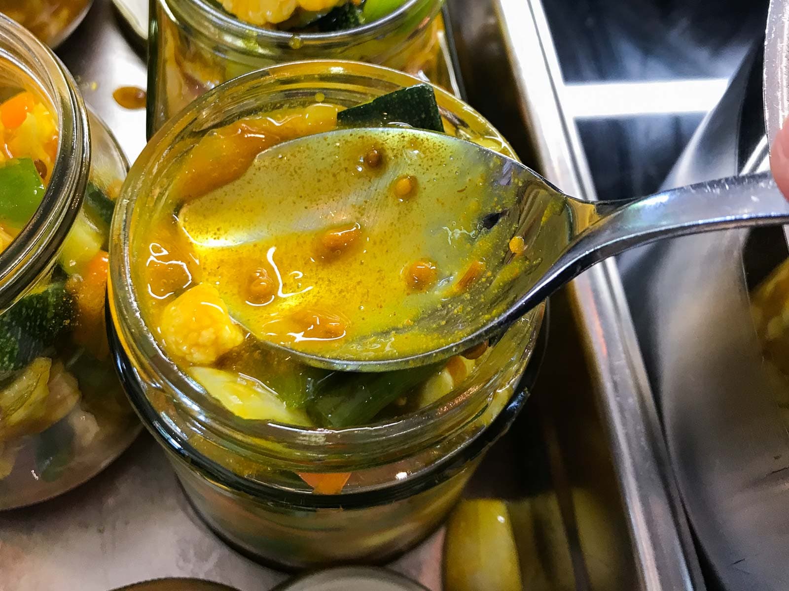 Piccalilli being added to sterile jars.