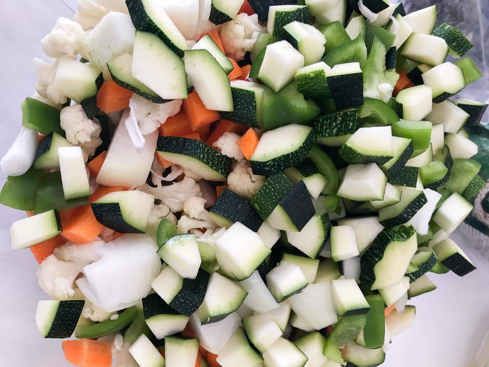 Vegetables, such as cauliflower, courgettes, carrots and onions chopped into bite sized pieces.