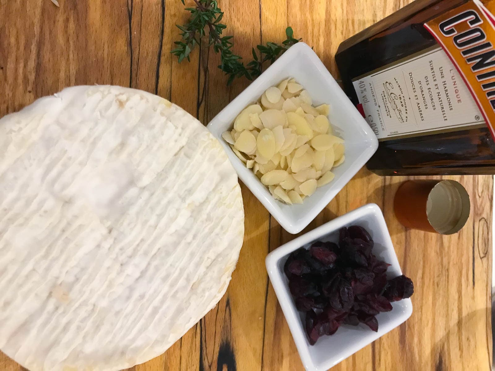 A whole camembert, some dried cranberries, sliced almonds and a bottle of Cointreau.