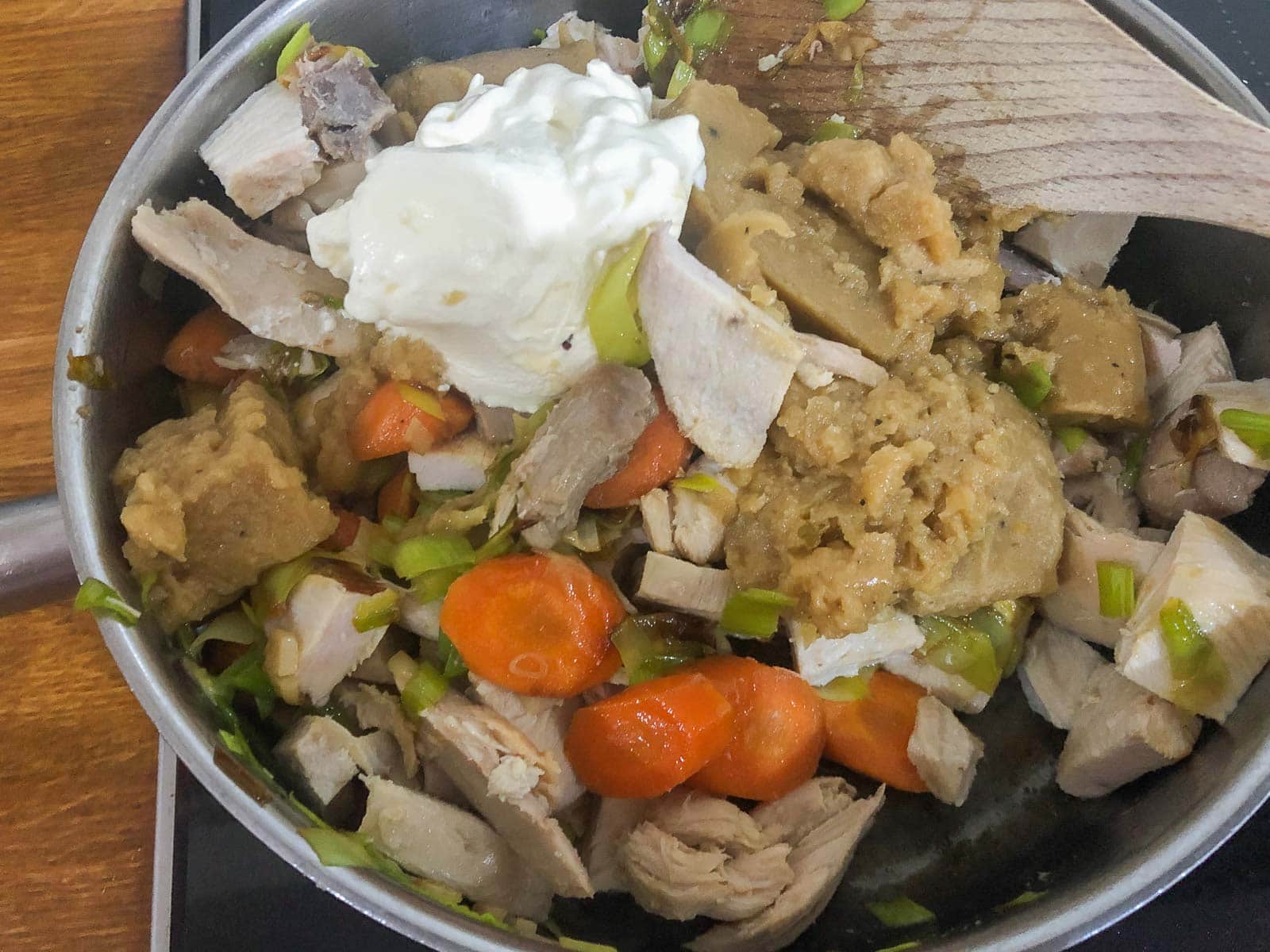 Leftover turkey, vegetables and gravy warmed with creme fraiche for a pie filing.