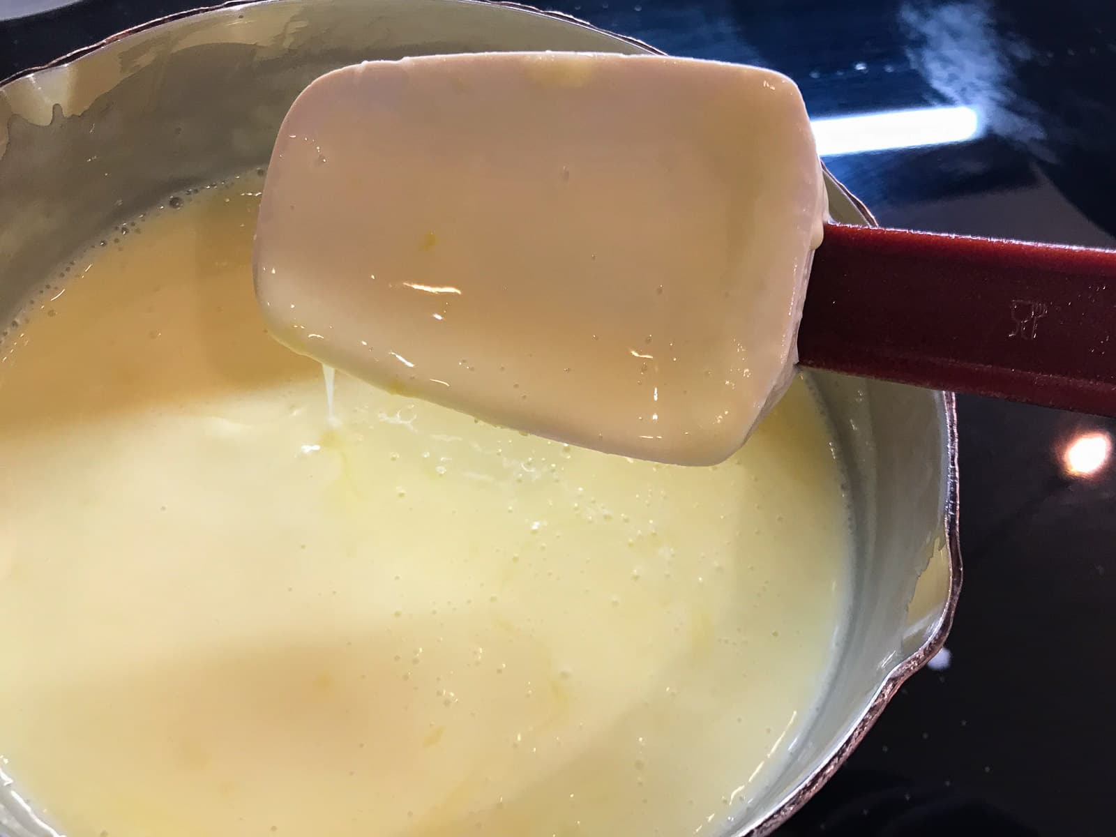 Lemon posset simmering in a pan.