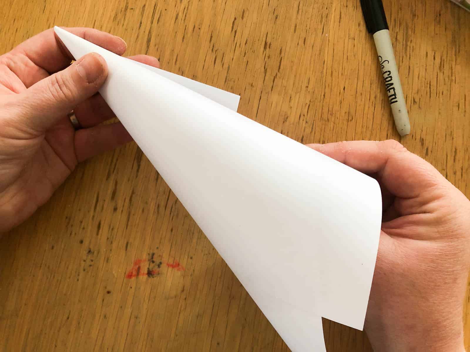 Folding an A4 sheet of paper into a cone.