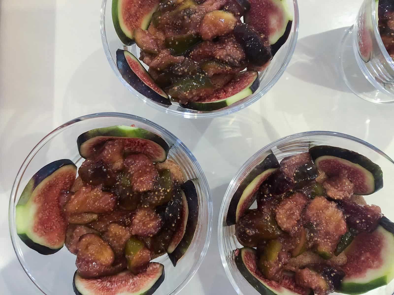 4 individual trifle jars layered with sherry soaked lady fingers, sliced figs and a sticky fig compote