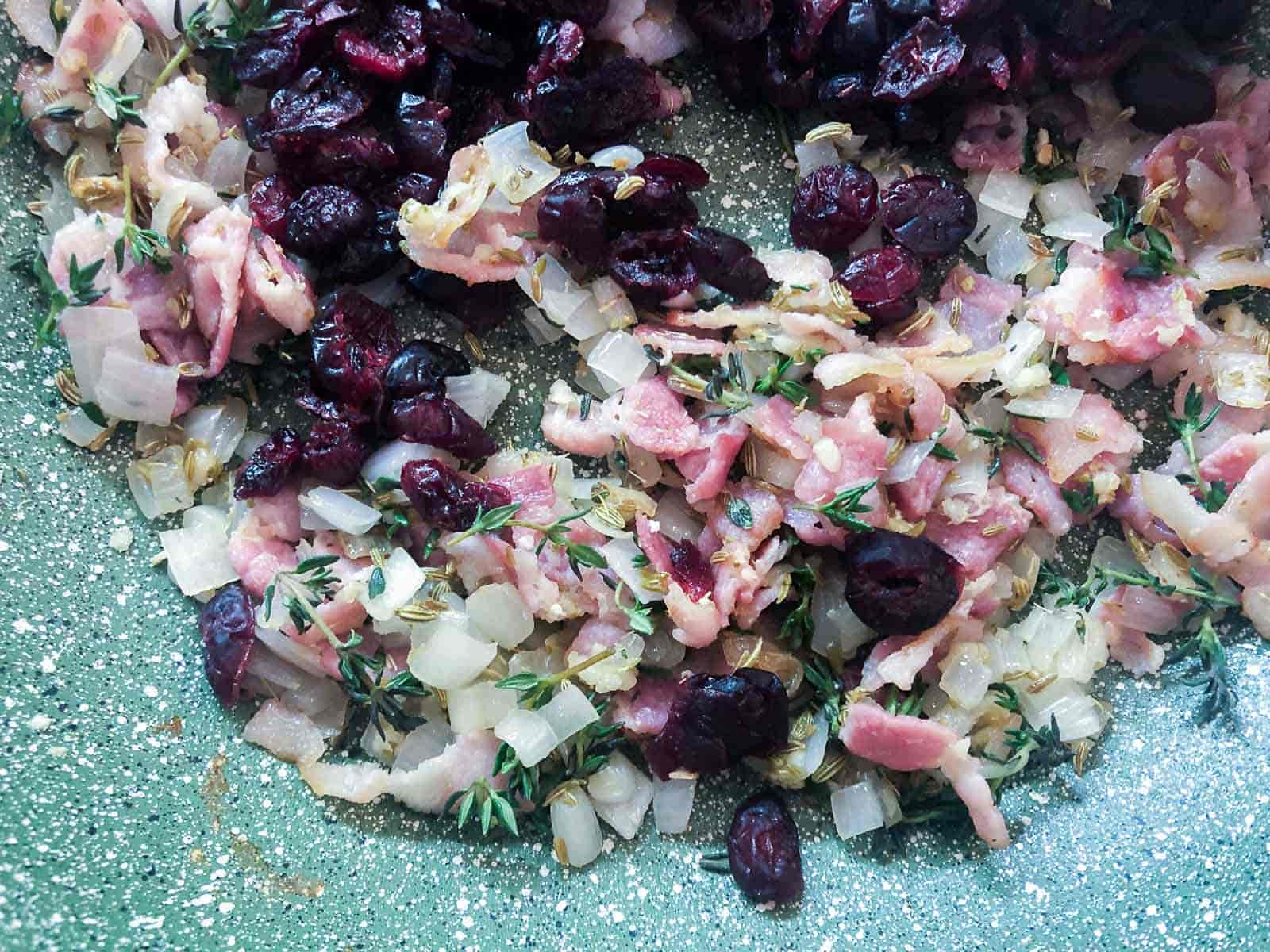Shallots, dried cranberries and herbs and spices to make a stuffing.
