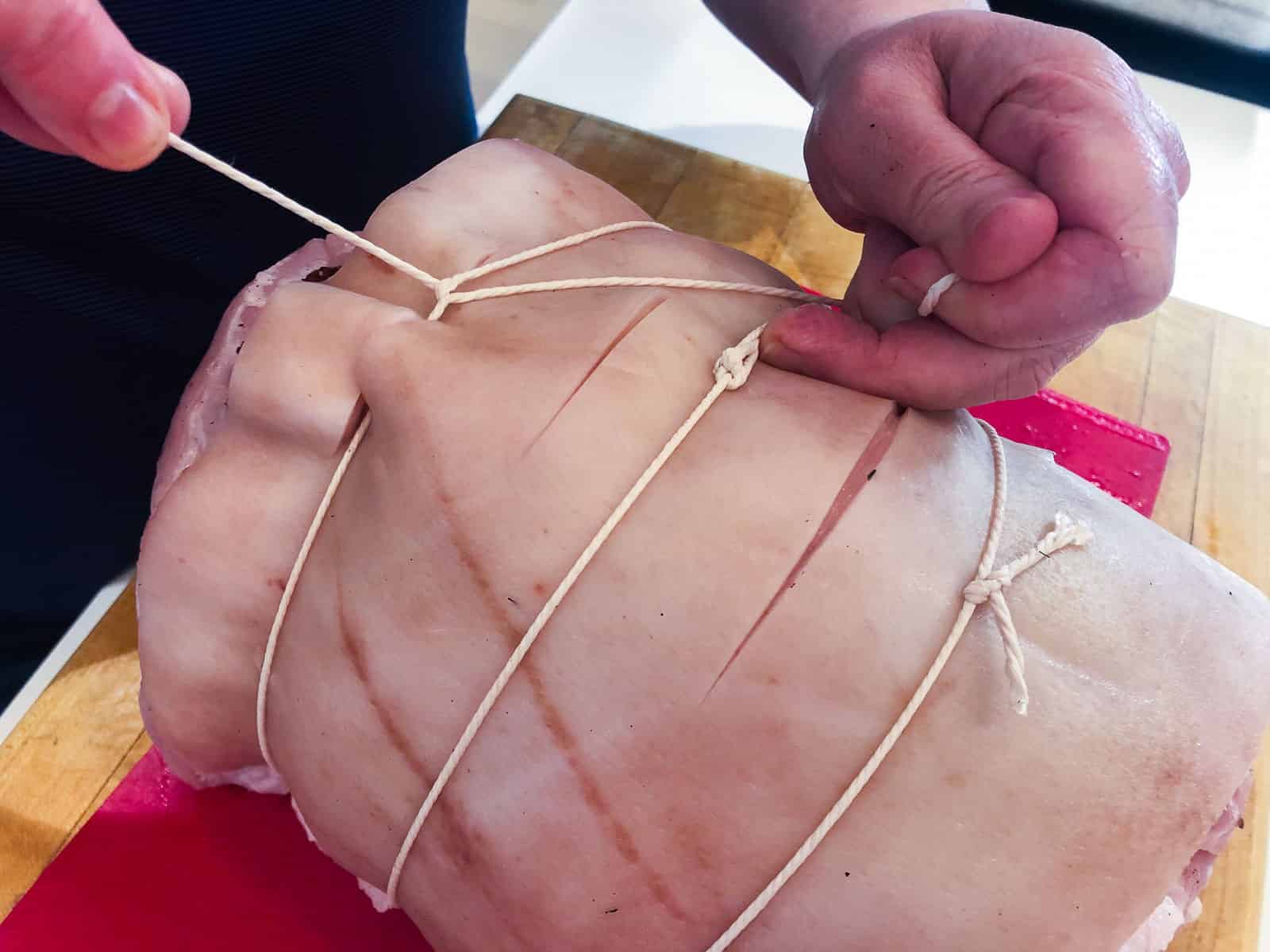 How to tie a pork leg roast that has been stuffed.