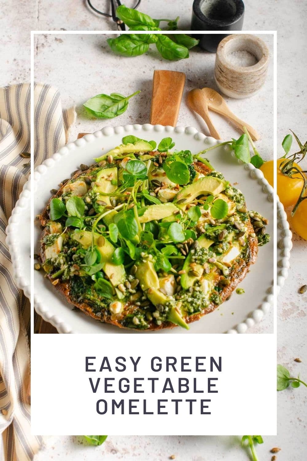 A pinterest graphic of a spinach omelette on a white plate served with basil leaves, fresh watercress and avocado.