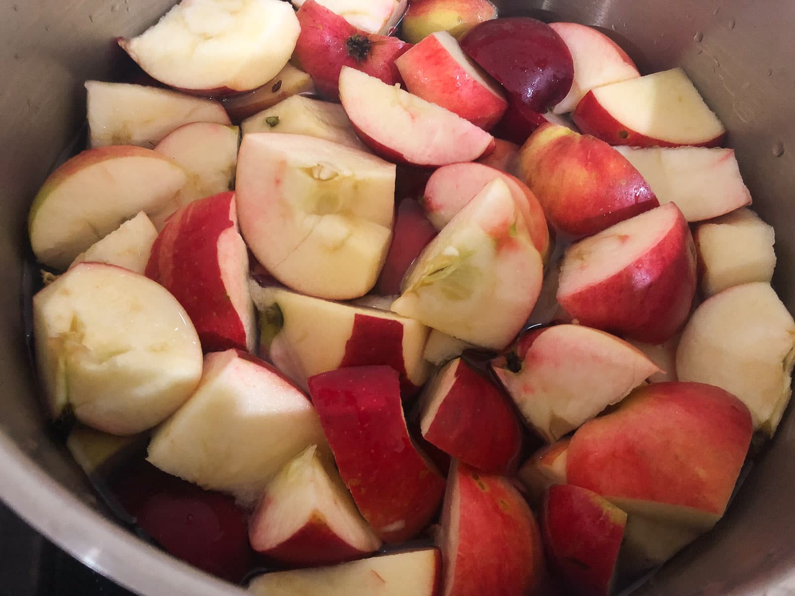 Chopped red apples sitting in a colander