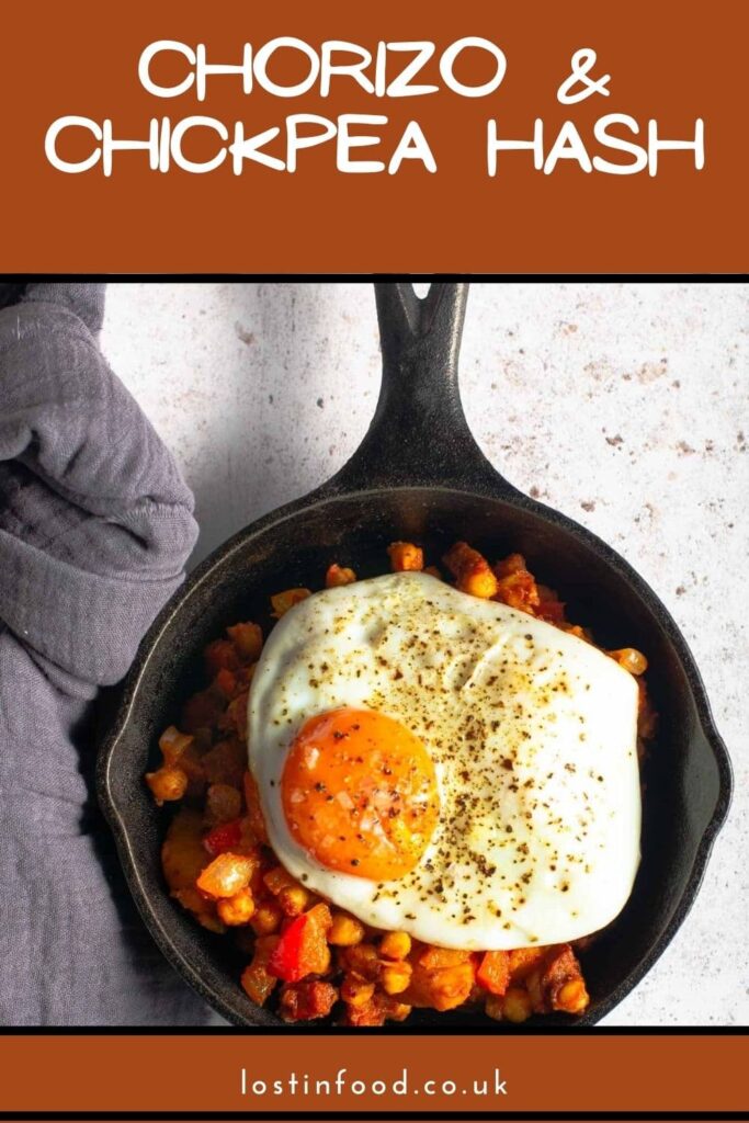 Pinterest graphic of a chorizo and chickpea brunch type dish in a small cast iron frying pan.