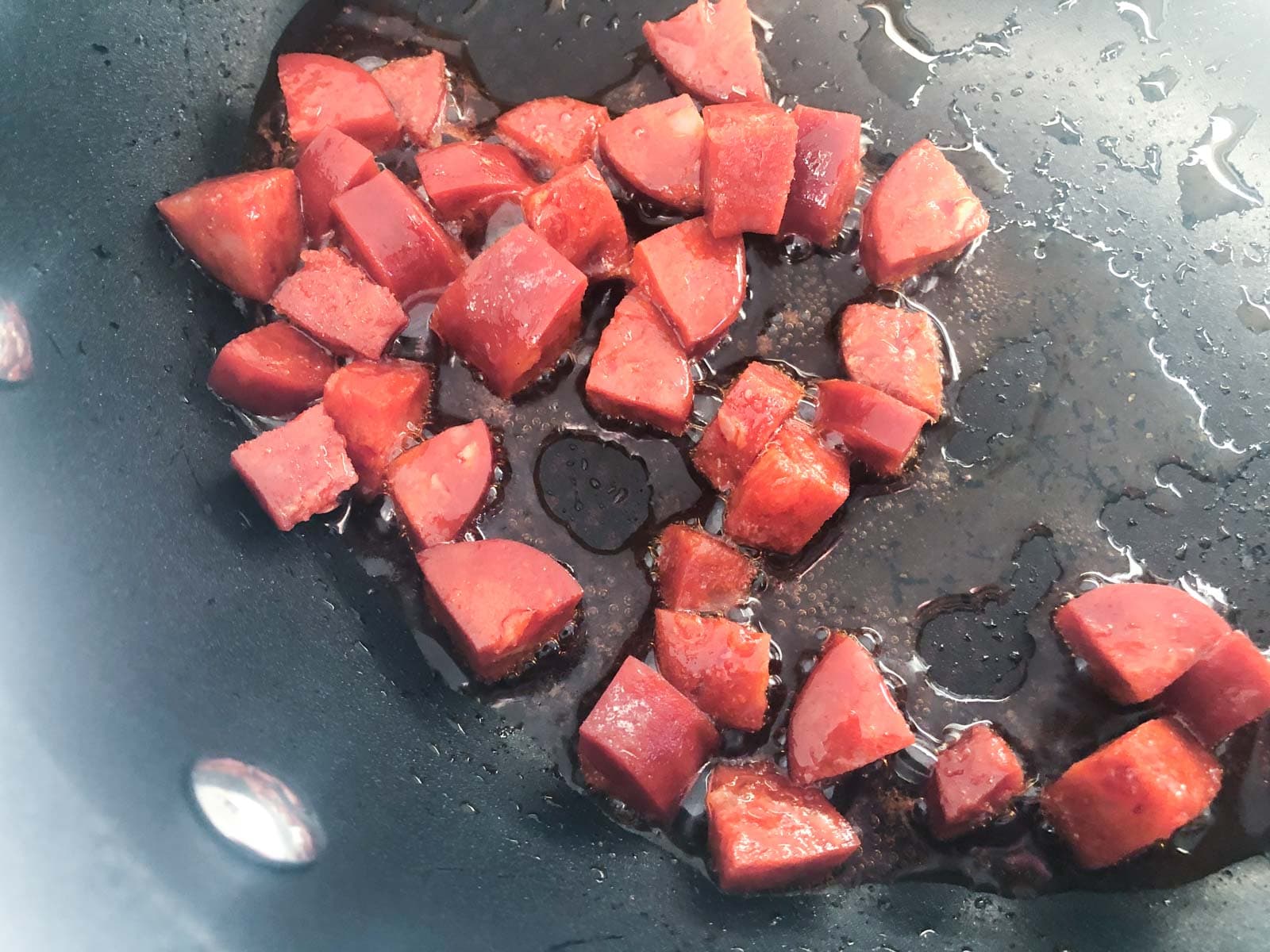 chorizo diced and gently sautéing in some oil in a pan.