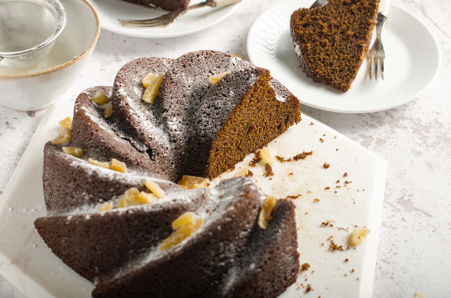 a bundt cake cut into servings and served on white plates