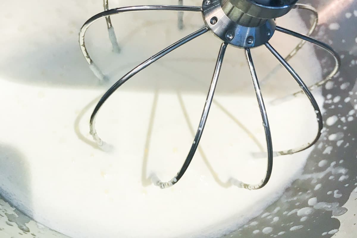 Whipping cream in a stand mixer.