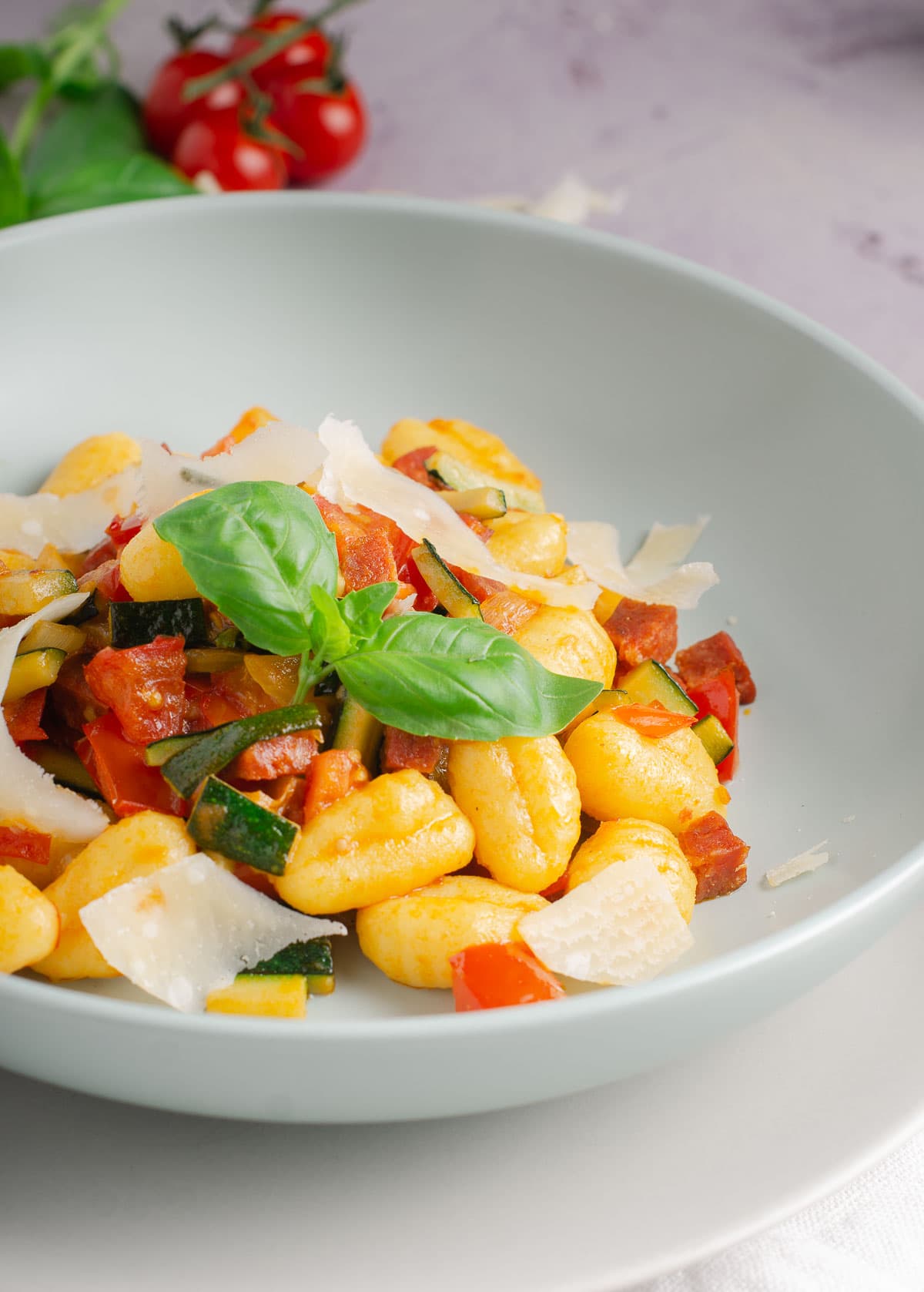 A fresh plate of gnocchi tossed with tomatoes, courgettes and chorizo.