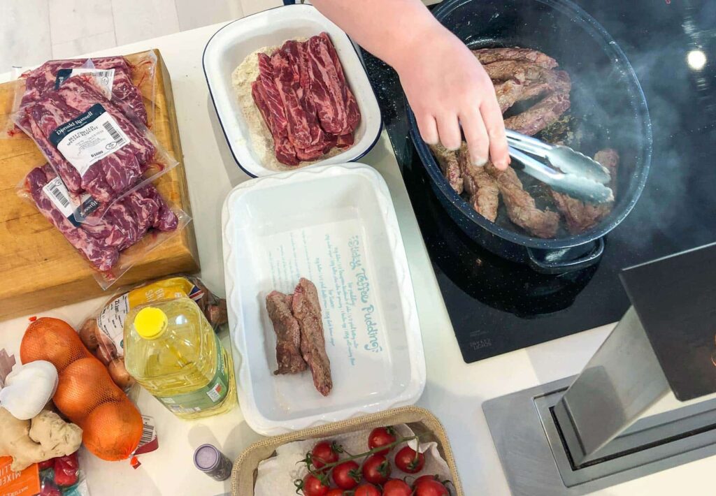 Cooking beef rib trim in a kitchen.