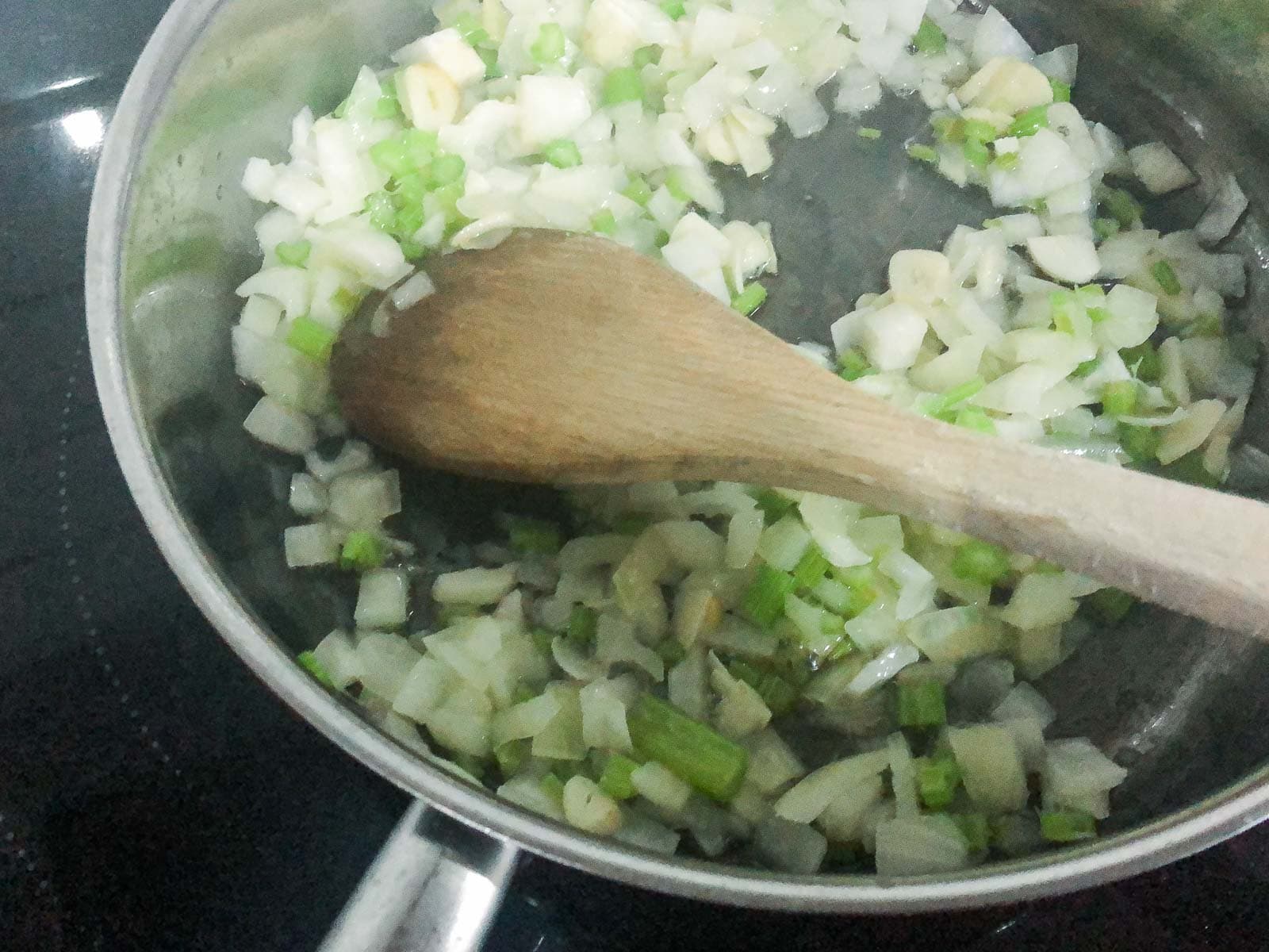 onions, garlic and celery sautéing in a pan.