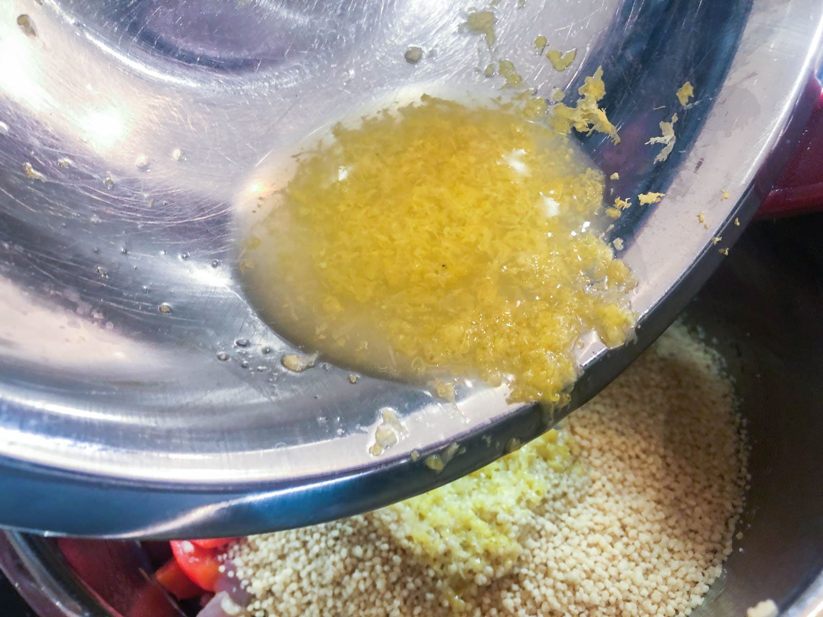 Adding lemon juice and zest to couscous.