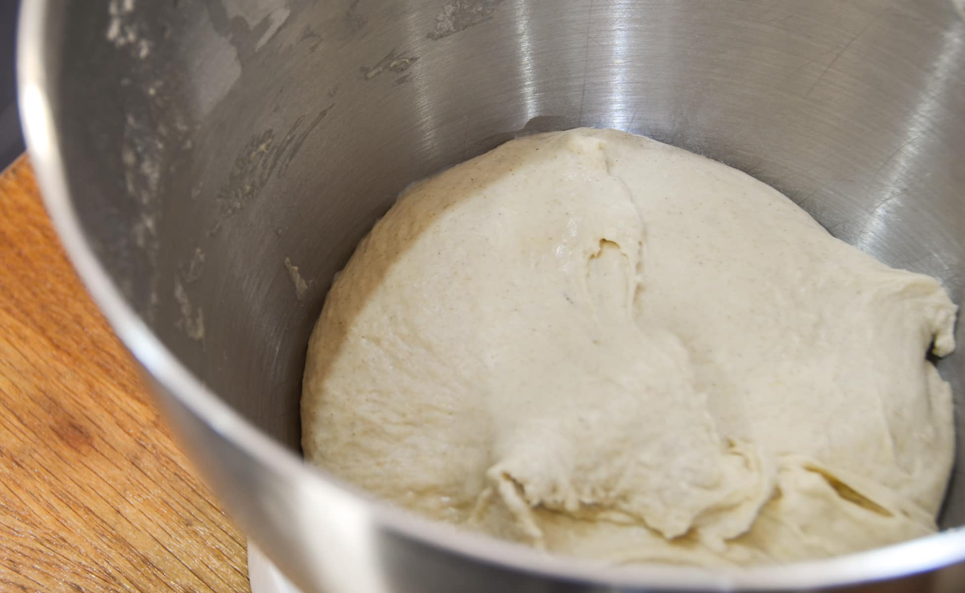 A dough made in a stand mixer ready to rise before using.